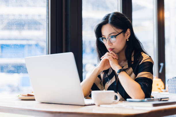 istock Asian woman working laptop at cafe. 1216129076