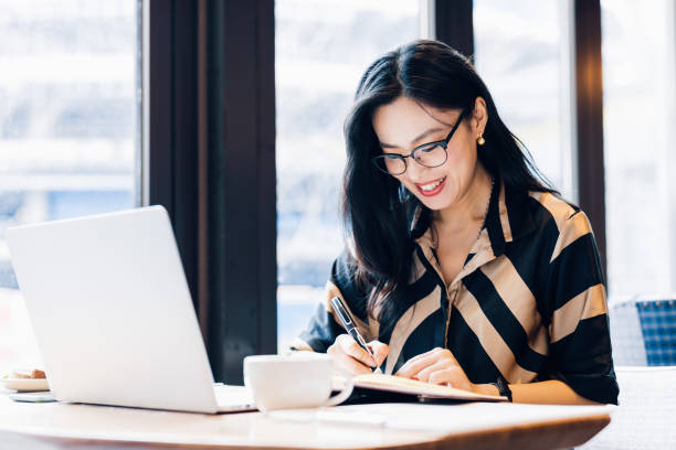 istock Asian woman working laptop at cafe. 1216129112