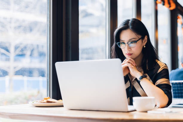 istock Asian woman working laptop at cafe. 1216129123
