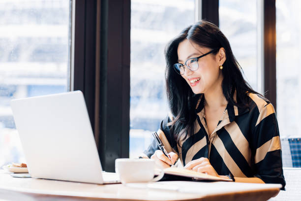 istock Asian woman working laptop at cafe. 1216129197