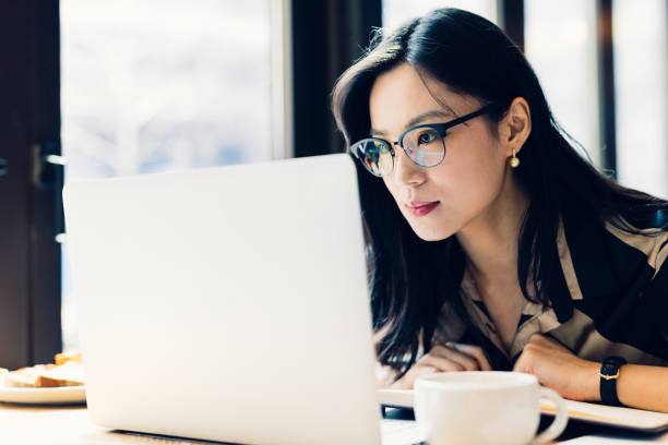 istock Asian woman working laptop at cafe. 1216129249