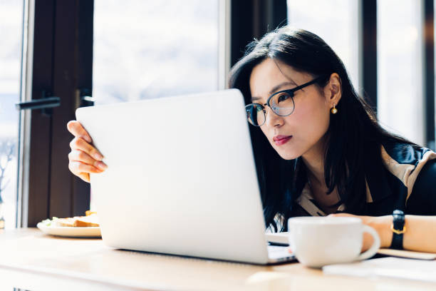 istock Asian woman working laptop at cafe. 1216129453