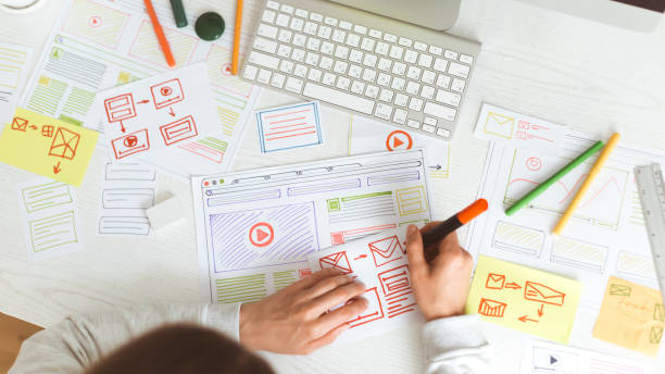 istock Web site designing. The designer draws a sketch of the application interface. 1216129763