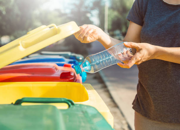 istock A plastic bottle is disposed of in a trash can. Sort in a garbage container. 1216130112