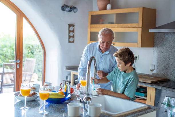 istock Grandfather and Grandson Making Breakfast in Kitchen 1216131114