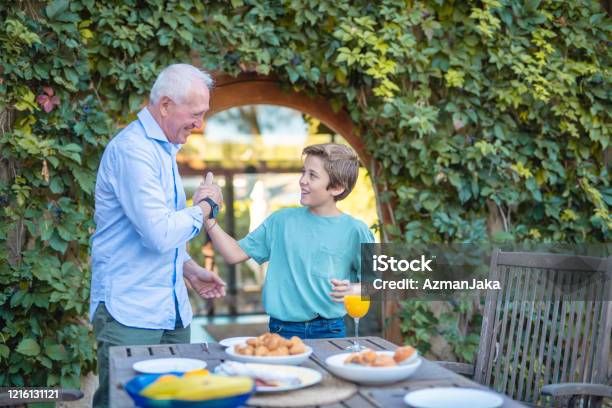 Homie Handshake Between Smiling Grandson And Grandfather Stock Photo - Download Image Now