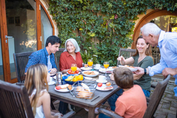 istock Three-Generation Family Enjoying Home Courtyard Breakfast 1216131157