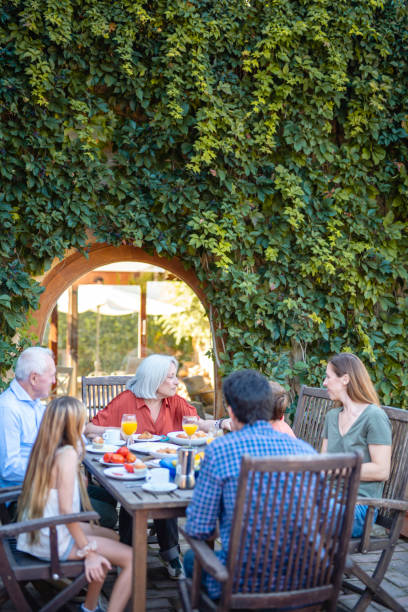 istock Seniors Smiling and Conversing with Grandson at Breakfast 1216131203
