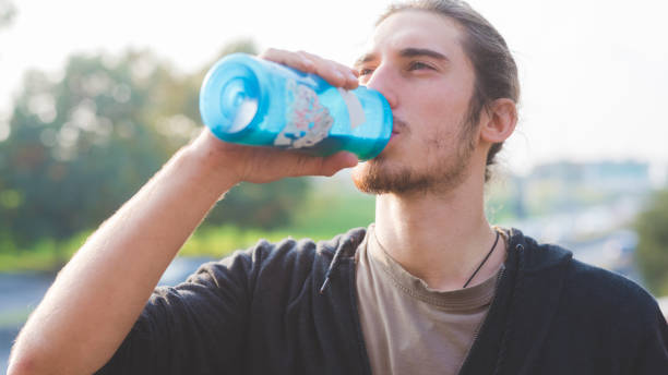 istock Young beautiful caucasian man relaxing after training drinking water 1216132527