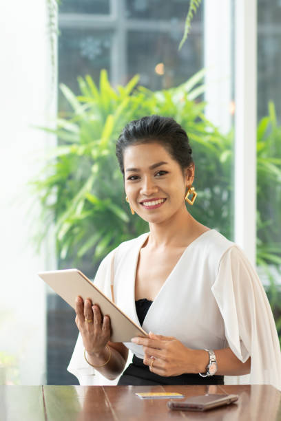 istock Young student woman use wireless internet learning and co-working at home on mobile tablet app. Modern girl people blogger couch on laptop education classroom online device, Social distancing in space 1216133761
