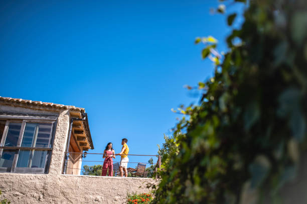 istock Young Male and Female Talking on Second Floor Home Terrace 1216134872