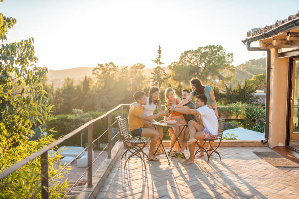 istock Laughing Friends Toasting at Summer Social Gathering 1216134943