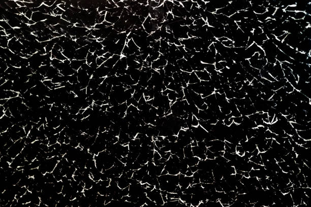istock Cracked glass texture on black background 1216135062