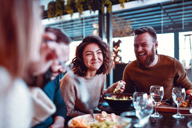 istock Friends Eating Dinner Together In Restaurant 1216137961