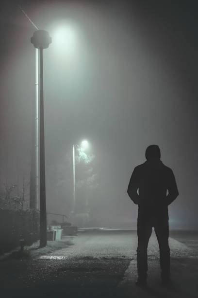 istock Creepy man standing in the dark 1216138679