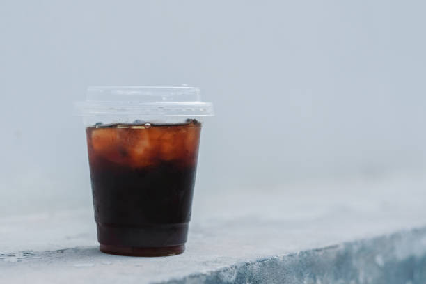 istock A glass of ice black coffee on white wall background 1216140954