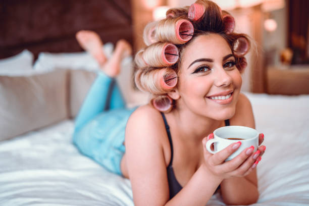 Beautiful Vintage Female With Hair Curlers And Her Cup Of Coffee Beautiful Vintage Female With Hair Curlers And Her Cup Of Coffee curling tongs photos stock pictures, royalty-free photos & images