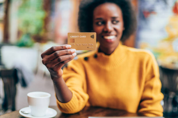 istock Woman holding a credit card 1216142381