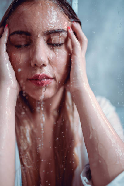 istock Female Taking A Shower In Clothes 1216142630