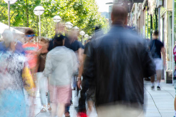 istock Blurred crowd of people walking on city sidewalk 1216144352