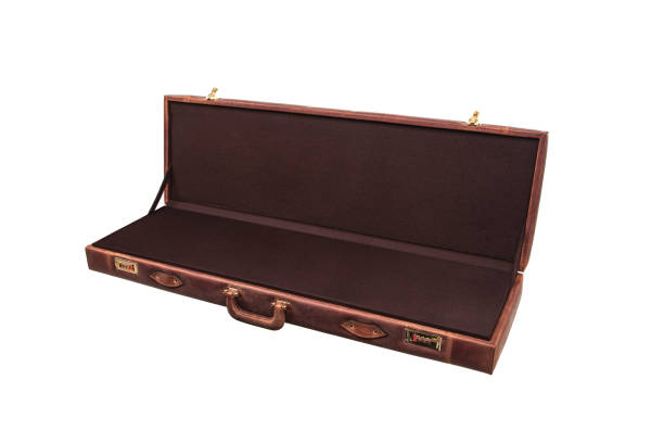 istock luxury brown leather case with gold-plated combination locks isolated on white background. Suitcase for weapons or musical instruments. 1216146079