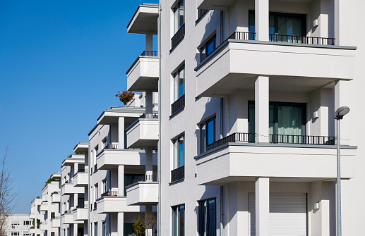 Row of new white apartment/ town- houses with balconies.