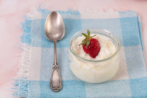Strawberries in a glass jar with spoon