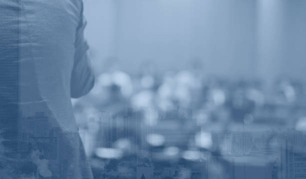 istock Speech given by professional speaker on stage at corporate conference. Executive manager giving presentation  to audience at leadership workshop for entrepreneurs. People receiving business education. 1216149821