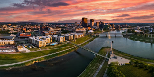 Colorful Downtown Sunset A panoramic aerial drone view over the confluence of the Great Miami and Mad Rivers looking toward downtown Dayton, Ohio under a colorful pink sunset. dayton ohio skyline stock pictures, royalty-free photos & images