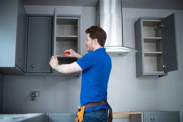 istock Rear View Of Carpenter Installing Luxury Modern Fitted Kitchen 1216157522