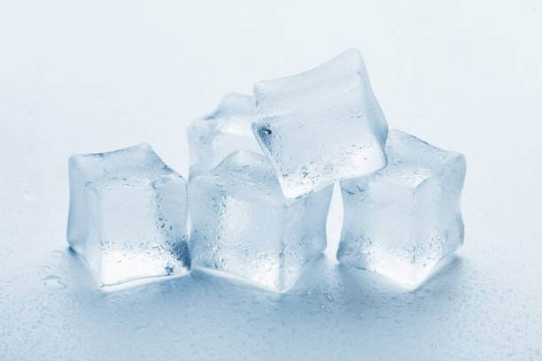 istock several melted ice cubes with drops on a light background with blue tinting 1216158783