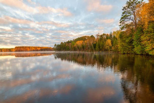 Fall trees reflecting lake stock photo