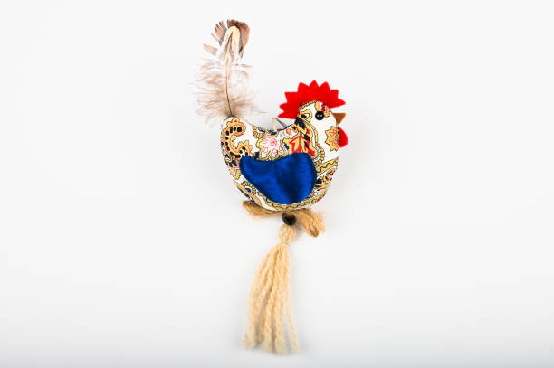 Multi-colored rooster, on a white background. View from above. Flat lay. Plush Rooster. Easter