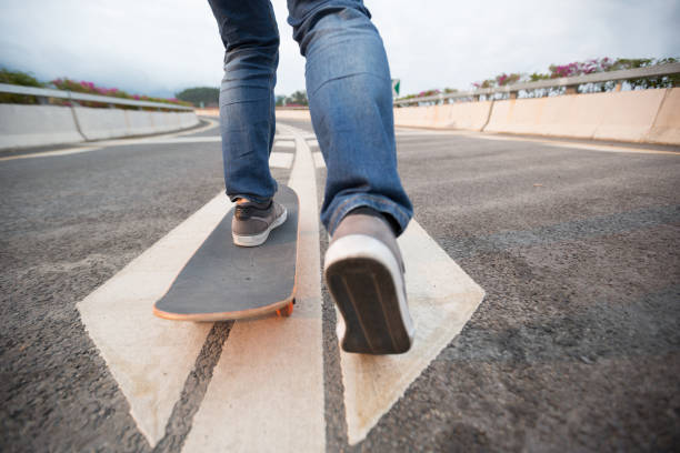istock Skateboarder skateboarding  on highway road 1216160170
