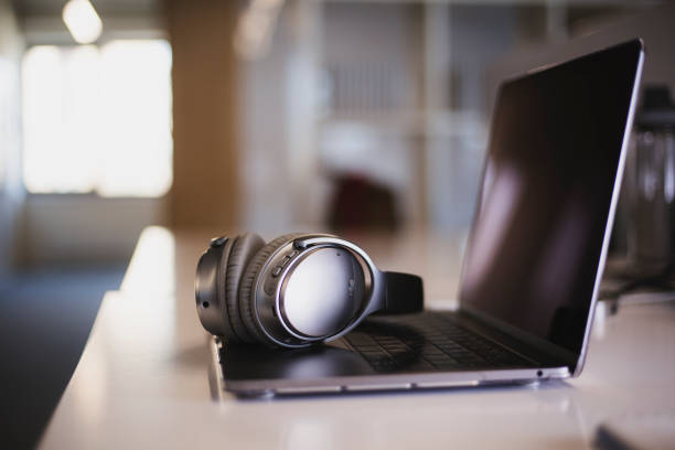 istock New headphones and laptop on the table 1216162629