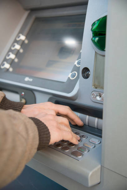 istock man who is withdrawing money at an ATM 1216164493