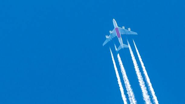 istock Four engined airplane during flight in high altitude with condensation trails 1216164614