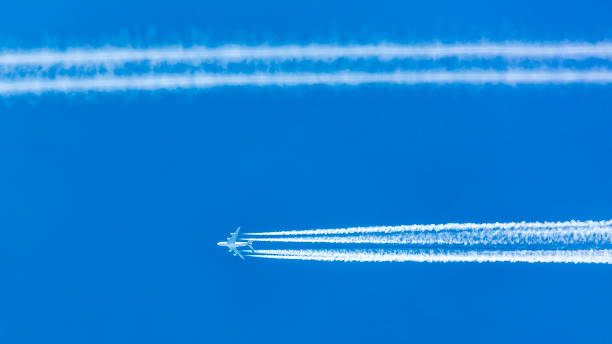 istock Four engined airplane during flight in high altitude with condensation trails 1216164762