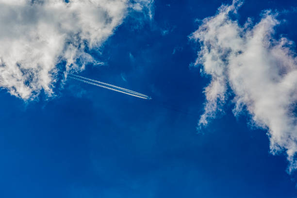 istock Four engined airplane during flight in high altitude with condensation trails 1216164926