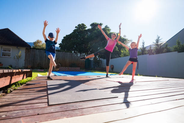 istock Mother and kids doing a home workout outdoors in their yard 1216165559