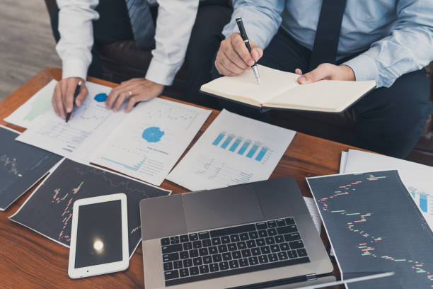 istock Working business man, team of broker or traders talking about forex on multiple computer screens of stock market invest trading financial graph charts data analysis. 1216167049