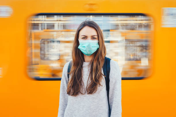 woman wearing a medical mask in a subway - blurred motion city life train europe imagens e fotografias de stock