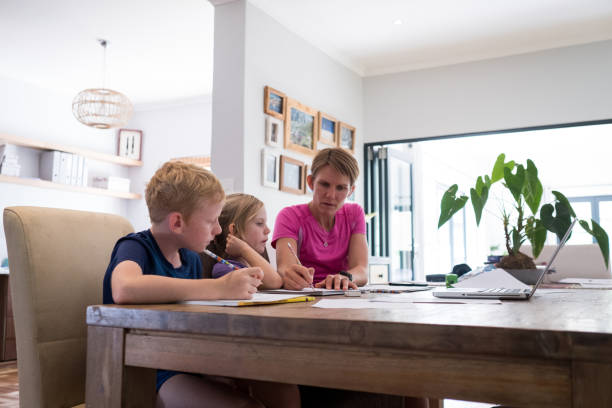 istock Mother homeschooling her children 1216167830