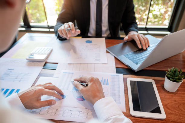 istock teamwork company meeting concept, business partners working with laptop computer together analysing startup financial project result or strategy plan and discussing data document in office 1216167836
