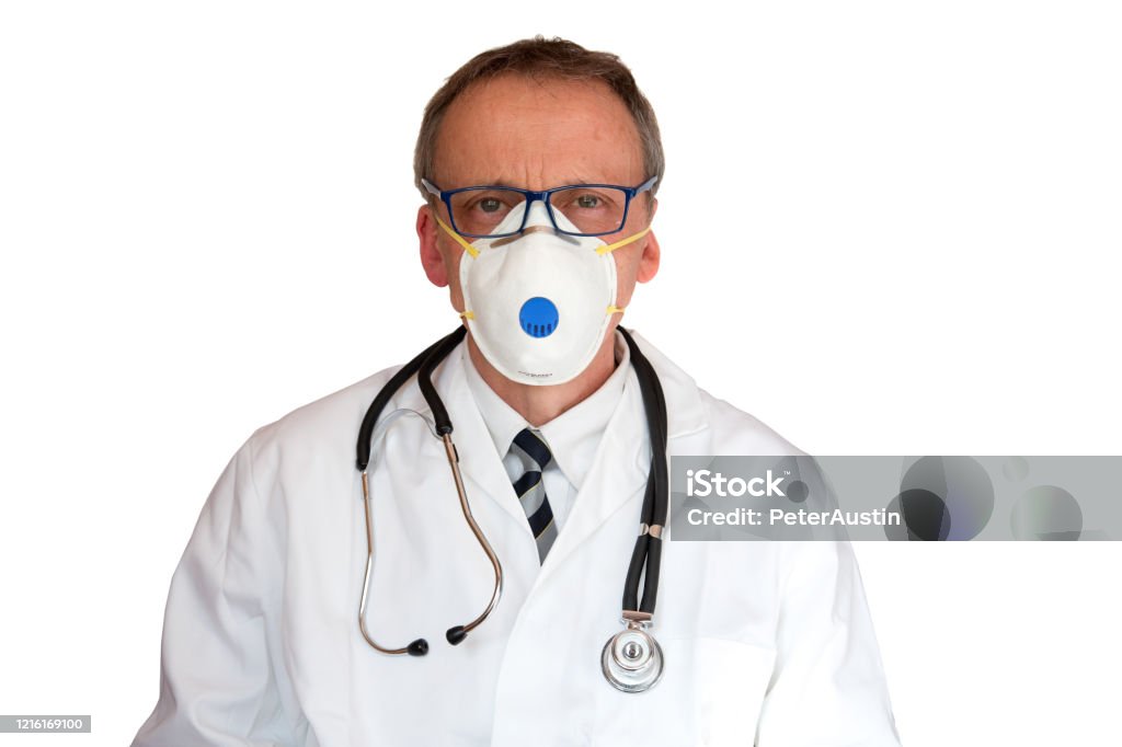 Doctor Wearing FFP3 Face Mask Doctor wearing FFP3 face mask in lab-coat with stethoscope isolated on white.
FFP3 is a standard and is currently minimum standard recommended in UK to protect against coronovirus. Care Stock Photo