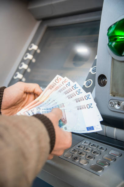 istock man who is withdrawing money at an ATM 1216169243