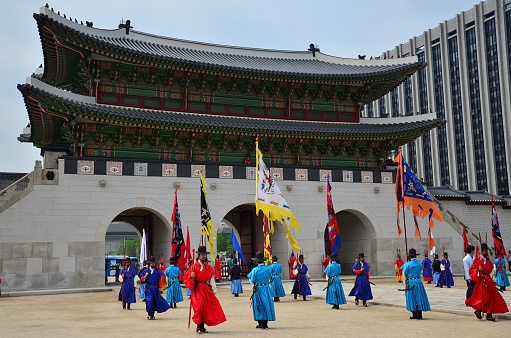 The Opening and Closing of the Royal Palace Gates and Royal Guard Changing Ceremonies at Gyeongbokgung Palace. Performer in traditional costume performing the tradition.
