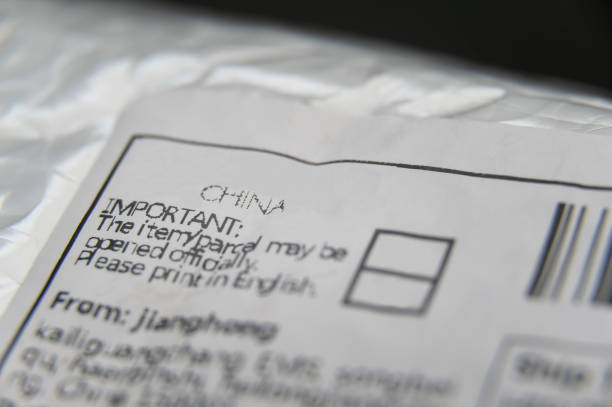 bubble pack padded envelope with close- up on mail from China label. Isolated on black background.