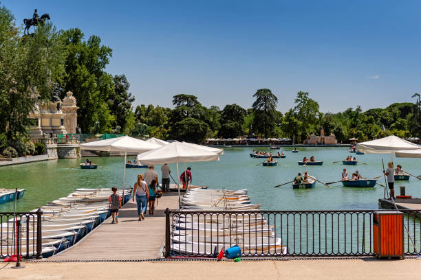 People on a Lake in Retiro Park Madrid, Spain - 19 July 2018: Buen Retiro Park Madrid, Spain. Biggest and famous Madrid public park. Lake in the park, place for rent a boat palacio de cristal photos stock pictures, royalty-free photos & images