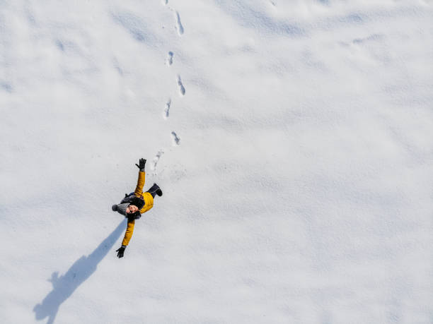 istock Aerial view woman standing in snow 1216171369
